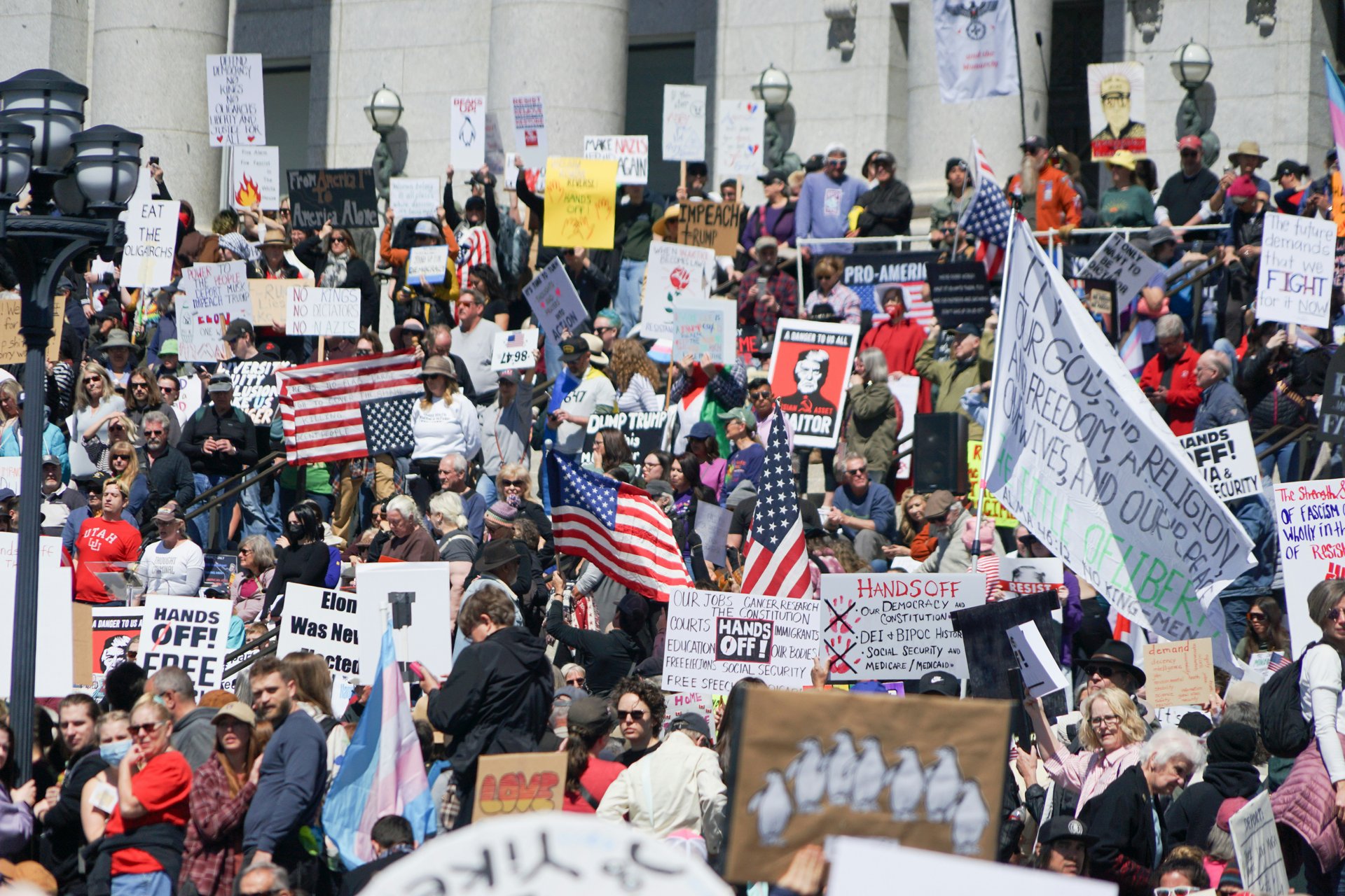 Utahns protest the actions of Donald Trump and Elon Musk outside the Utah State Capitol.